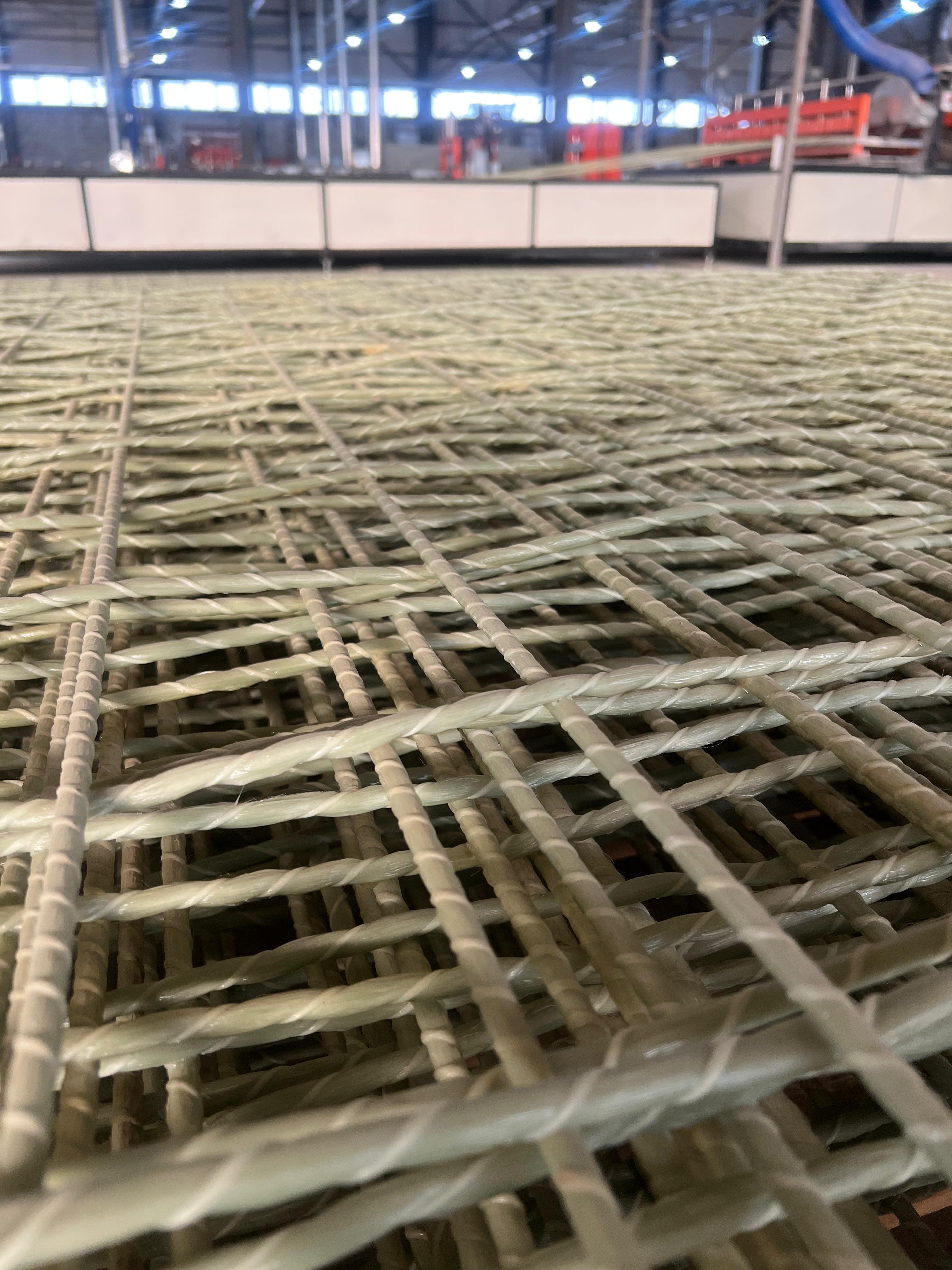 Close-up of woven fiberglass mesh panels in the factory